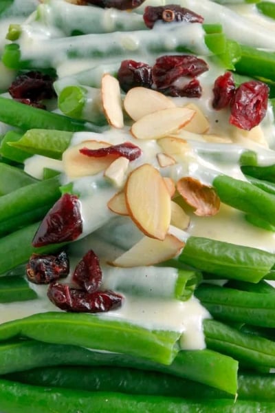 Green Beans in Mascarpone Cream Sauce is a sophisticated and delicious update to the old green bean casserole. It is sure to become a family favorite. #greenbeans #mascarponecreamsauce www.savoryexperiments.com