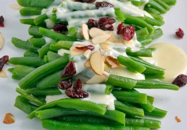 Green Beans in Mascarpone Cream Sauce is a sophisticated and delicious update to the old green bean casserole. It is sure to become a family favorite. #greenbeans #mascarponecreamsauce www.savoryexperiments.com