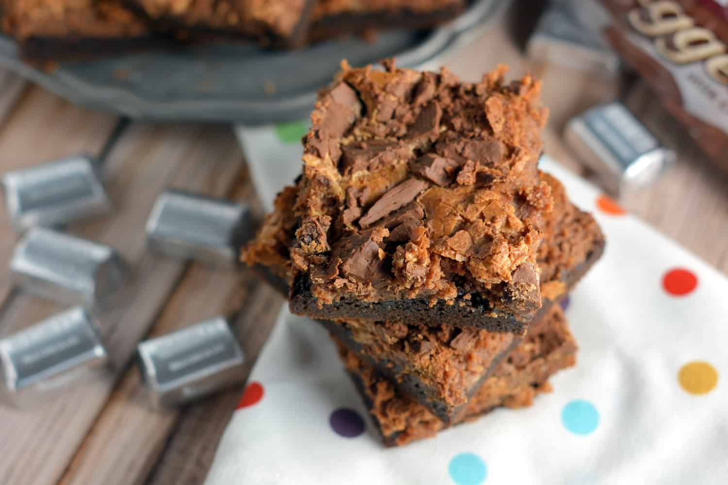 Triple Chocolate Cookies Cheesecake Bars Recipe- Soft and Chewy with a fudge cake mix cookie crust and chocolate cheesecake topped with milk chocolate crumbles. A chocolate lover's dream come true!