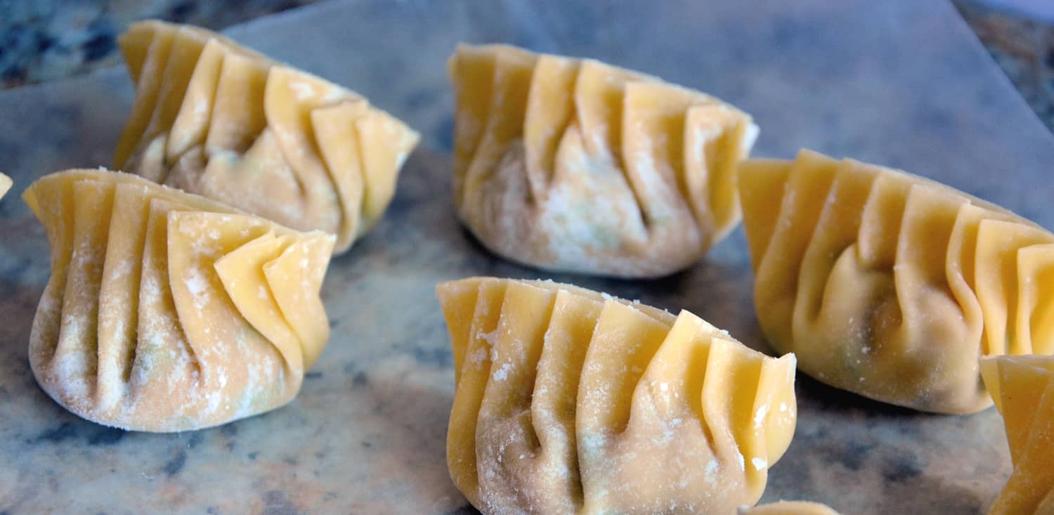 Authentic Chinese Dumplings is a recipe straight from a Chinese restaurant owner. Learn how to make perfect little folds and the fry and steam techinque of cooking. #chinesedumplings #porkdumplings www.savoryexperiments.com 