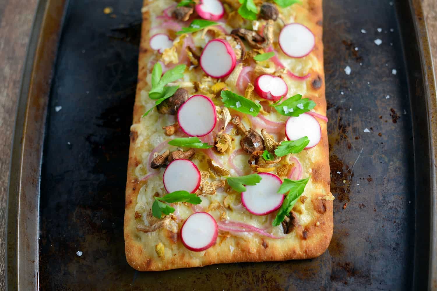 Horseradish and Mushroom Flatbread can be served as an appetizer or entree, perfect for your vegetarian friends, but hearty enough for meat-eaters. A mushroom blend, fresh radishes, pickled red onion, tangy horseradish cheddar cheese, Italian parsley and Maldon sea salt make this one of the best dishes you will ever eat!