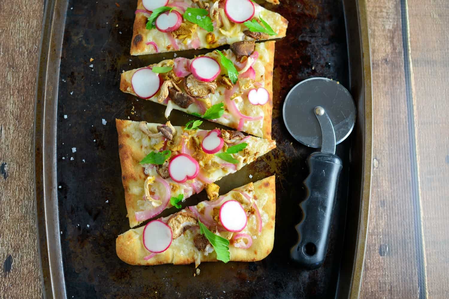 Horseradish and Mushroom Flatbread can be served as an appetizer or entree, perfect for your vegetarian friends, but hearty enough for meat-eaters. A mushroom blend, fresh radishes, pickled red onion, tangy horseradish cheddar cheese, Italian parsley and Maldon sea salt make this one of the best dishes you will ever eat!