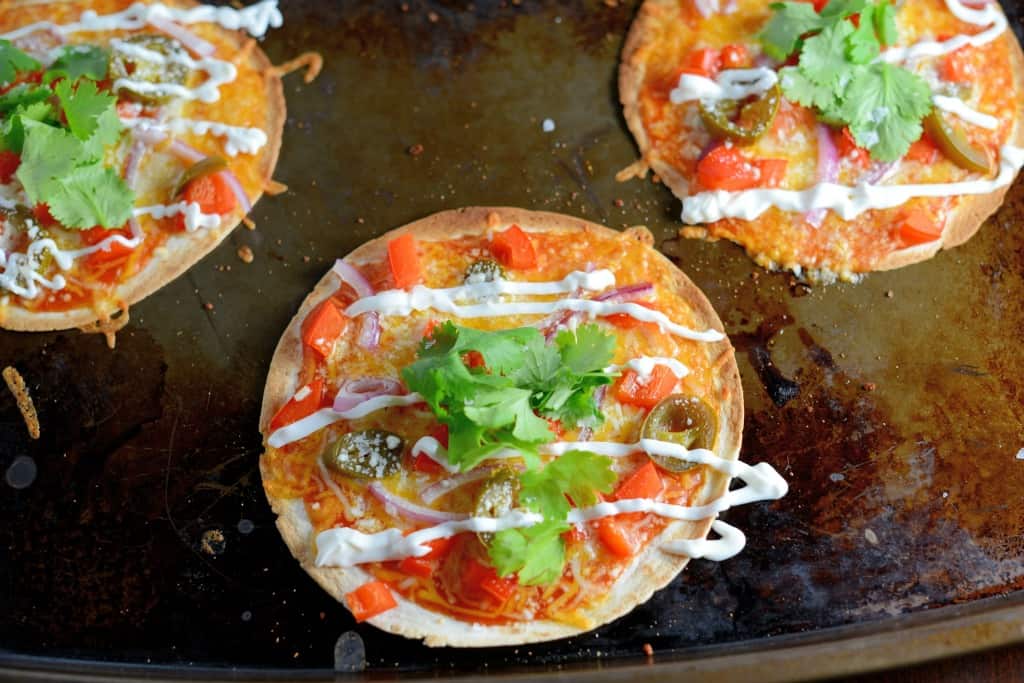 Homemade Mexican Pizza is one of our favorite game day recipes! Set up a pizza bar and allow guests to create their own! Cheese, bright veggies and zesty flavors, you can't go wrong