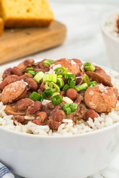 angle view of red beans and rice in a white bowl