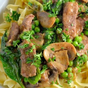 Skinny Beef Stroganoff use a secret ingredient to make this into a low calorie creamy dish. Add peas and spinach for extra veggie! #beefstroganoff www.savoryexperiments.com