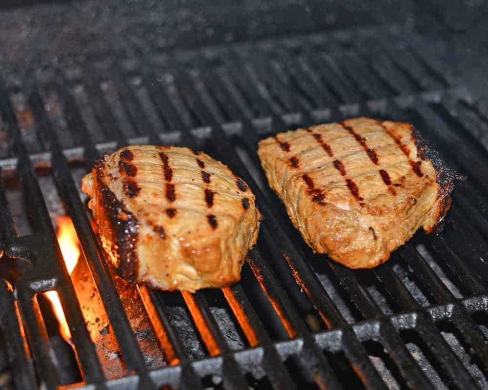Grilled Dijon Pork Chops are a favorite for pork on the grill. A zesty and easy pork marinade recipes perfect for grilled or baked pork chops! #porkchopsonthegrill #grilledpork www.savoryexperiments.com