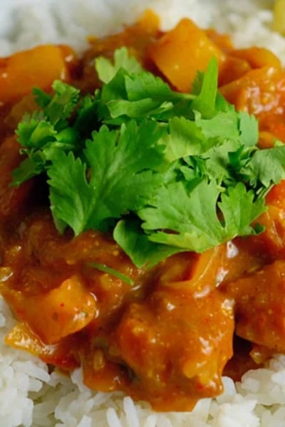 A close up of a plate of food with rice and vegetables, with Curry and Pork