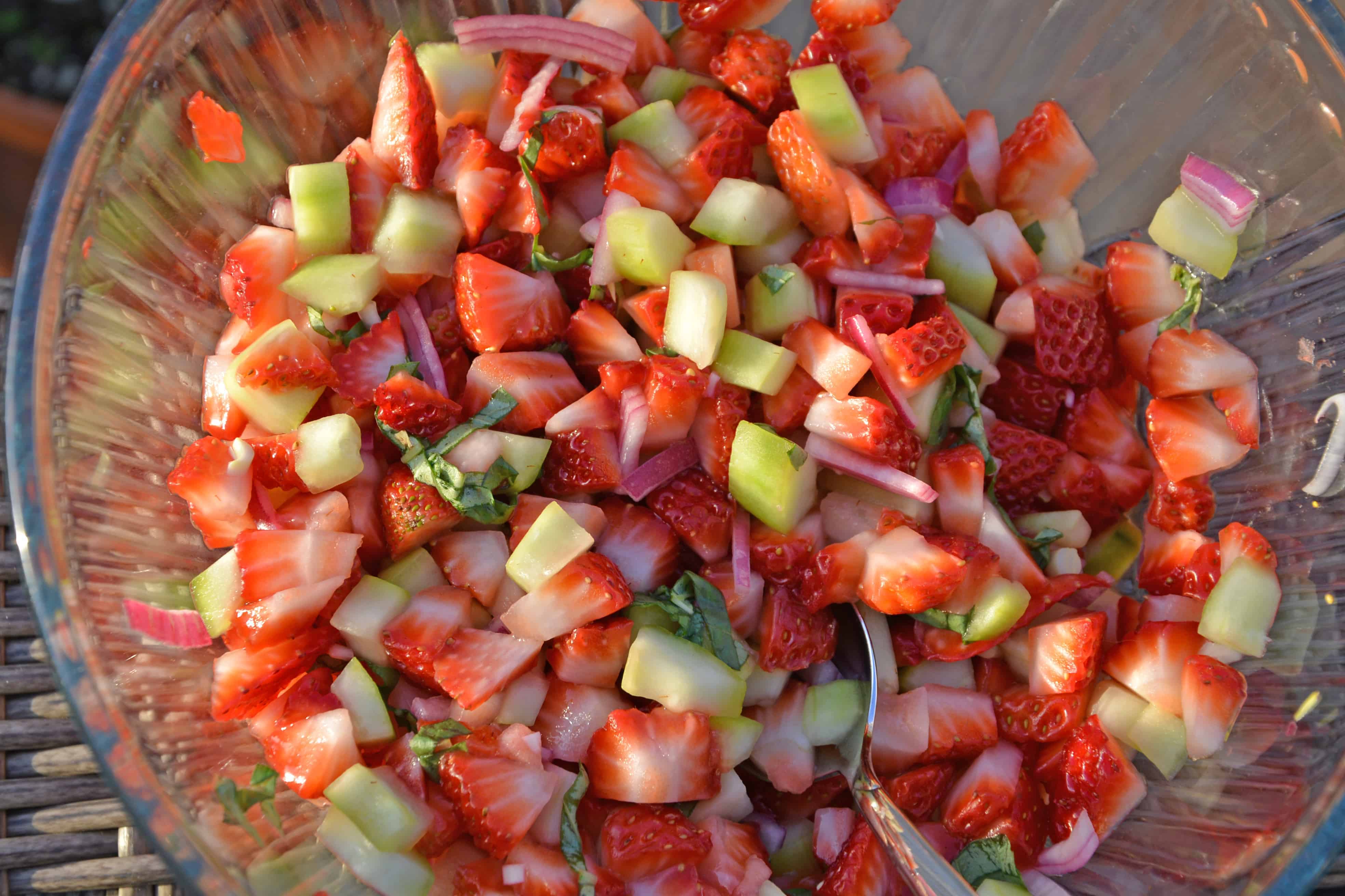 This Strawberry Salsa recipe uses sweet strawberries with cooling cucumber, red onion, basil and zesty white wine vinegar for a juicy dip or condiment. #homemadesalsa #fruitsalsa #strawberrysalsa www.savoryexperiments.com 
