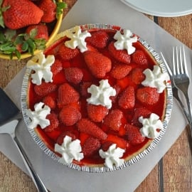 No-Bake Strawberry Cream Cheese Pie- A no-bake pie made with graham cracker crust, a layer of sweet cream cheese, loads of fresh strawberries and a homemade strawberry jelly. All ready in less than 20 minutes! www.savoryexperiments.com