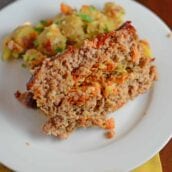 Veggie Stuffed Meatloaf Recipe- The most tender meatloaf ever! Stuffed with carrot and zucchini and topped with a zesty ketchup blend with a special ingredient. Come see what makes this meatloaf one even meatloaf-haters will LOVE! www.savoryexperiments.com
