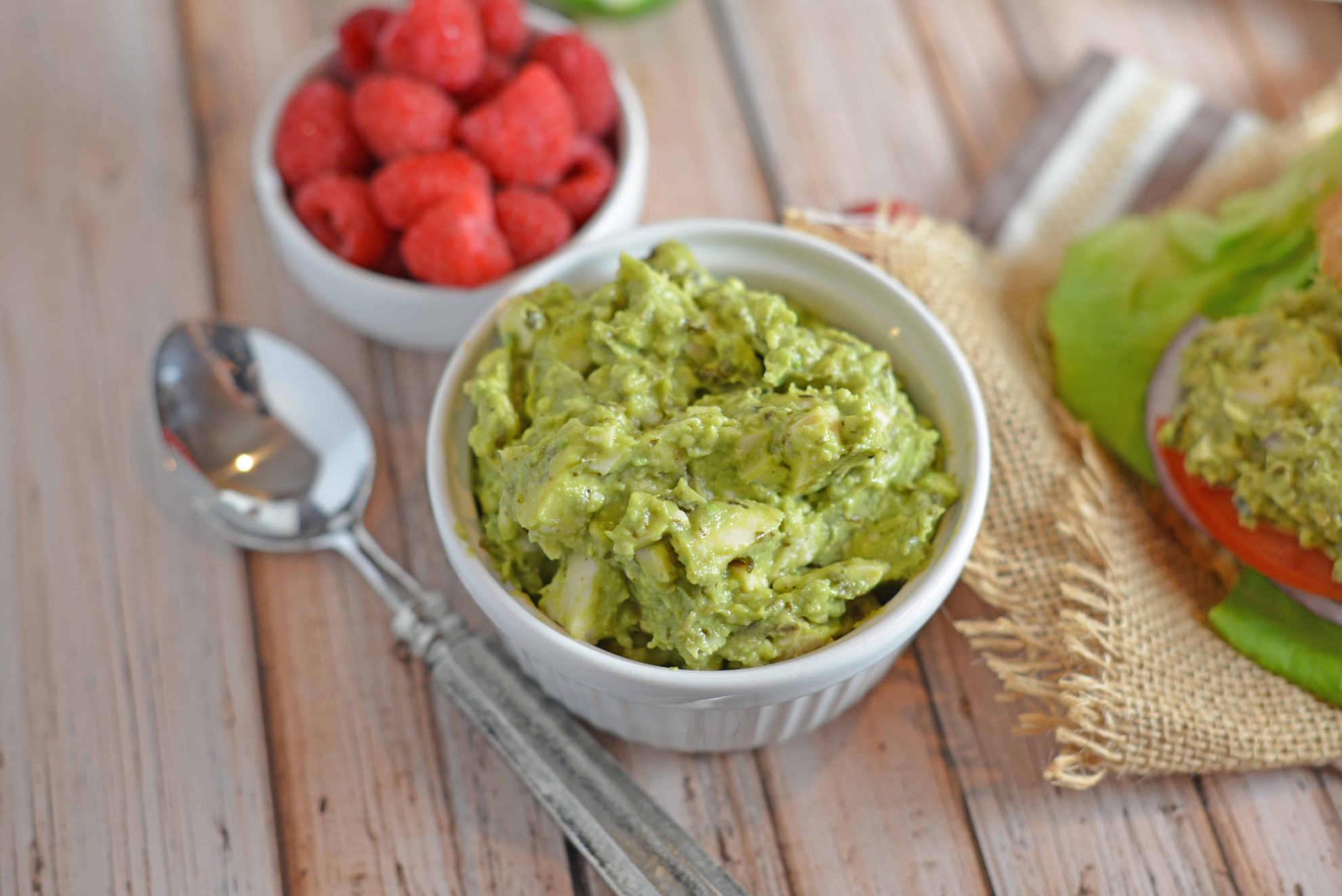 Pesto Avocado Chicken Salad swaps out the heavy mayonnaise for creamy avocado. Pesto adds flavor and lime juice brightens shredded chicken from precooked rotisserie chicken. #healthychickensalad #avocadochickensalad #easychickensalad www.savoryexperiments.com