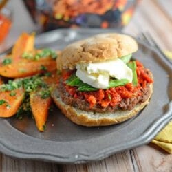 Caprese Burger Recipe - an easy sun dried tomato pesto, fresh basil and mozzarella cheese with your choice of caramelized onions and balsamic reduction. This is the best burger ever! www.savoryexperiments.com