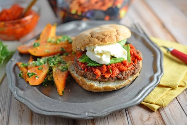Caprese Burger Recipe - an easy sun dried tomato pesto, fresh basil and mozzarella cheese with your choice of caramelized onions and balsamic reduction. This is the best burger ever! www.savoryexperiments.com