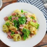 Creamy Tortellini and Ham Pasta - An easy pasta recipe ready in just 20 minutes! Peas, broccoli, ham and cheese tortellini! www.savoryexperiments.com