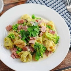 Creamy Tortellini and Ham Pasta - An easy pasta recipe ready in just 20 minutes! Peas, broccoli, ham and cheese tortellini! www.savoryexperiments.com