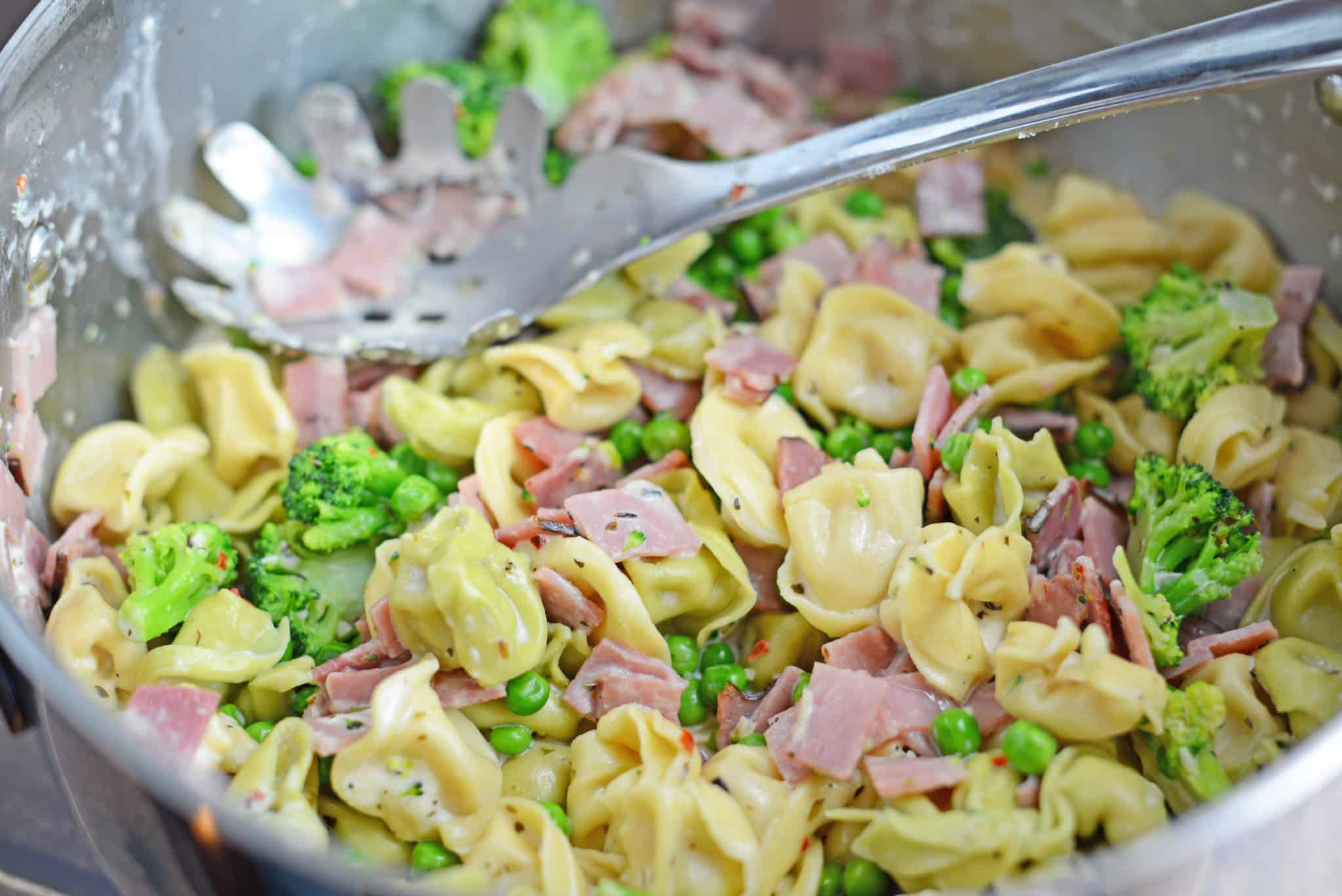 Creamy Tortellini and Ham Pasta - An easy pasta recipe ready in just 20 minutes! Peas, broccoli, ham and cheese tortellini! www.savoryexperiments.com