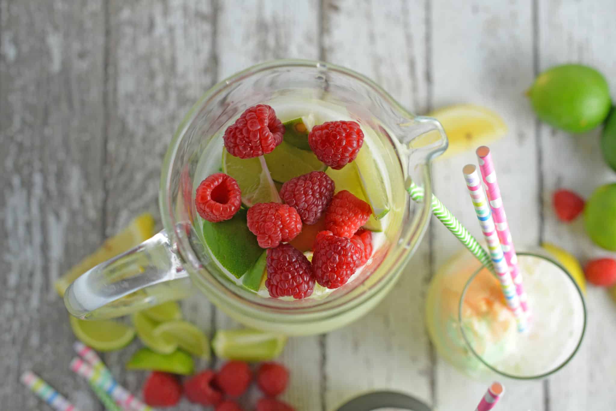 Frozen Limeade Sherbet Floats- a refreshing summer drink perfect for parties and BBQs! Cool limeade blended with ice and topped with a heaping scoop of rainbow sherbet! Perfect for kids, but an adult option available. www.savoryexperiments.com