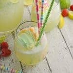 Frozen Limeade Sherbet Floats- a refreshing summer drink perfect for parties and BBQs! Cool limeade blended with ice and topped with a heaping scoop of rainbow sherbet! Perfect for kids, but an adult option available. www.savoryexperiments.com