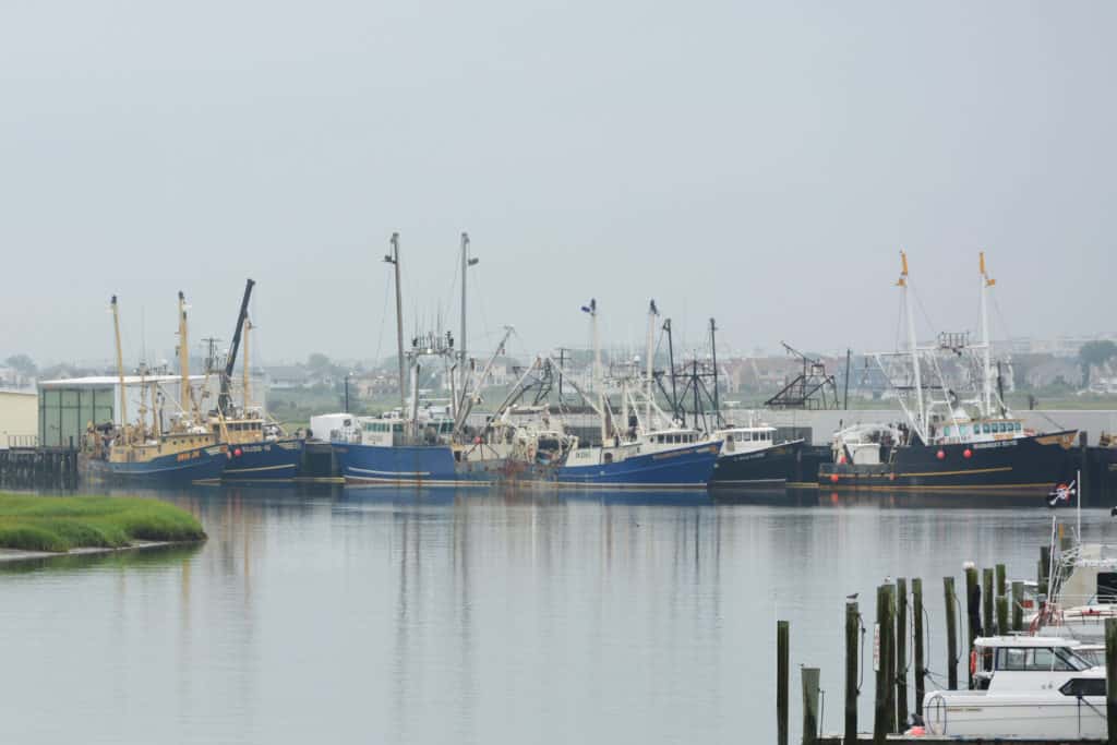 A boat is docked next to a body of water