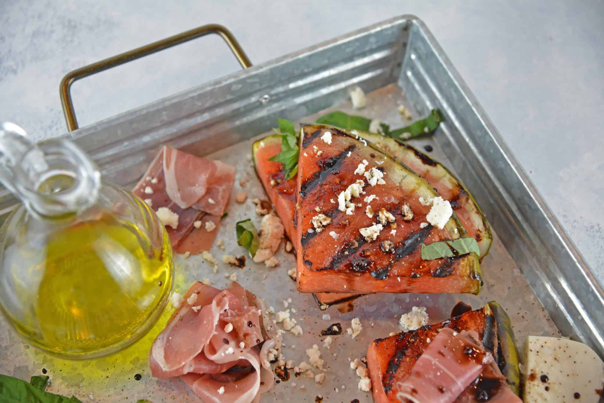 Grilled Watermelon Steaks with balsamic reduction and feta cheese are an easy BBQ side dish. Caramelized, juicy watermelon with savory cheese and sticky reduction is delicious! #grilledwatermelon #watermelonrecipes www.savoryexperiments.com 