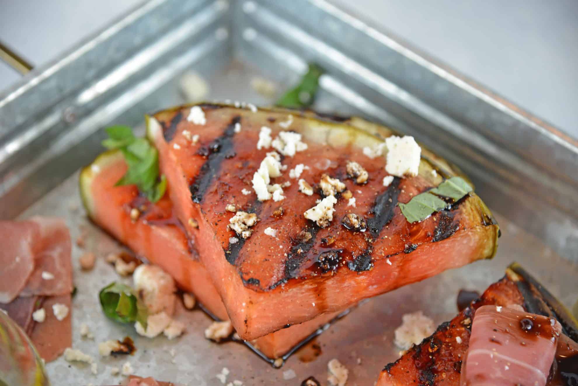 Grilled Watermelon Steaks with balsamic reduction and feta cheese are an easy BBQ side dish. Caramelized, juicy watermelon with savory cheese and sticky reduction is delicious! #grilledwatermelon #watermelonrecipes www.savoryexperiments.com