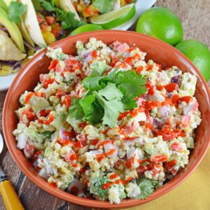 Mexican Corn Salad Recipe - Traditional Mexican street corn is turned into the best salad ever. Lime, Mexican cheese with avocado, red onions and crema mexicana. It's so good, just grab a spoon!
