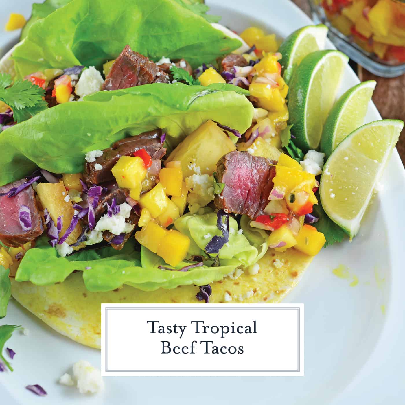 Tropical Beef Tacos use seasoned strip steak with mango salsa and queso fresco. Plus one secret for out-of-this-world tacos! #softtacos #beeftacos #streettacos www.savoryexperiments.com