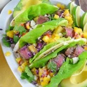 Tropical Beef Tacos Recipe - the secret for interesting and amazing soft tacos! Easy soft tacos with mango salsa, queso fresco and red cabbage. www.savoryexperiments.com