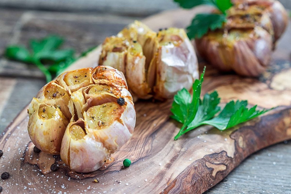 roasted garlic on a wood board