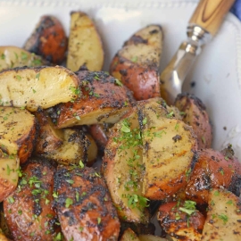 Herb Grilled Potatoes uses miracle whip and a handful of spices to keep those spuds nice and moist with loads of flavor! Make this easy side dish today! #grilledpotatoes #grilledpotatowedges www.savoryexperiments.com