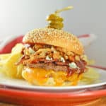 The best burger! Cowboy Burger is double patties with cheddar, blue cheese, onion strings, BBQ sauce, bacon and topped with honey habanero pickles.