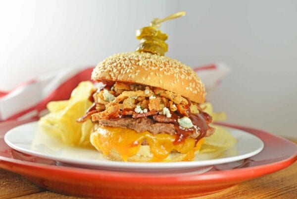 cowboy-burger The best burger! Cowboy Burger is double patties with cheddar, blue cheese, onion strings, BBQ sauce, bacon and topped with honey habanero pickles.