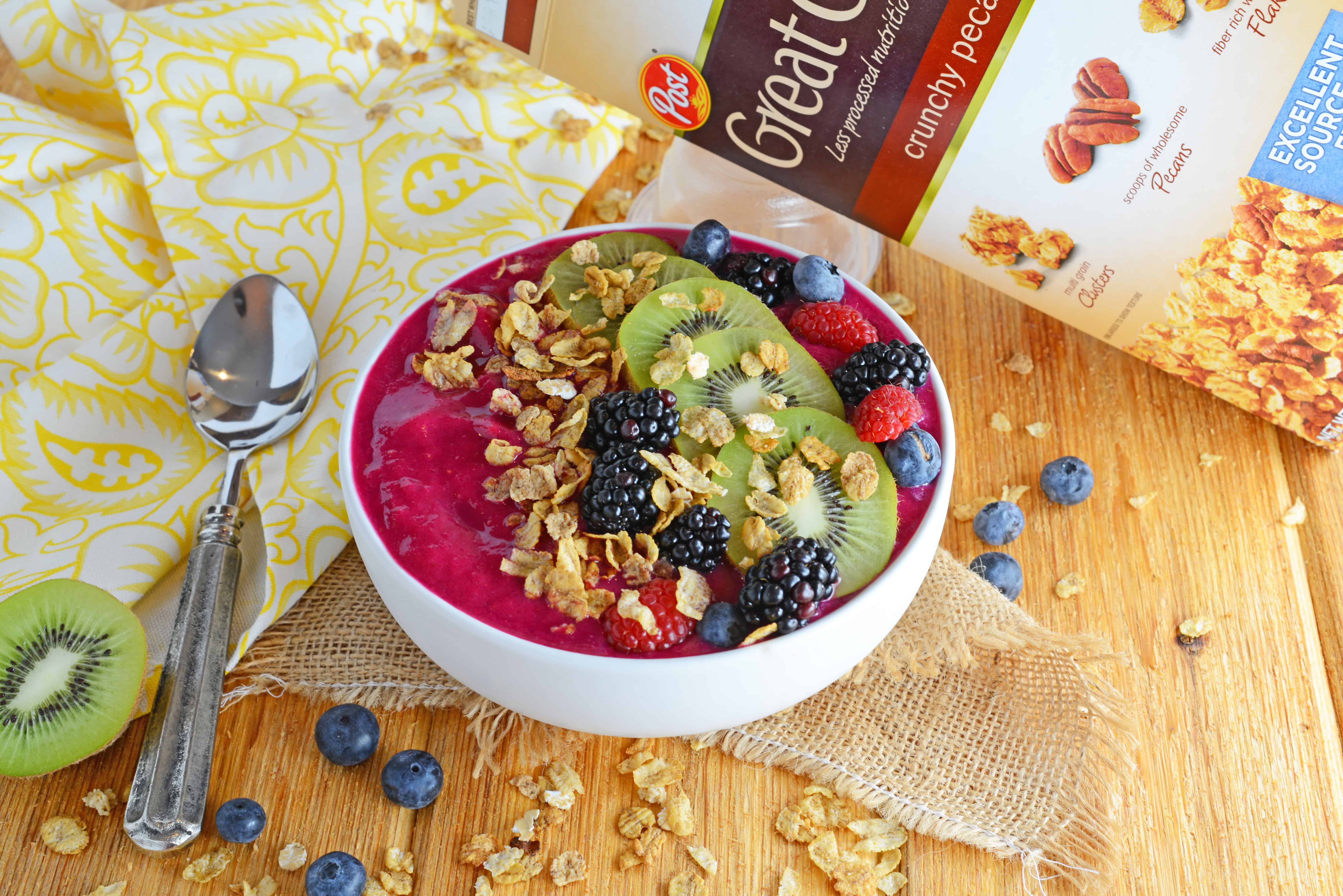 angle view of acai bowl topped with fresh fruit and granola 