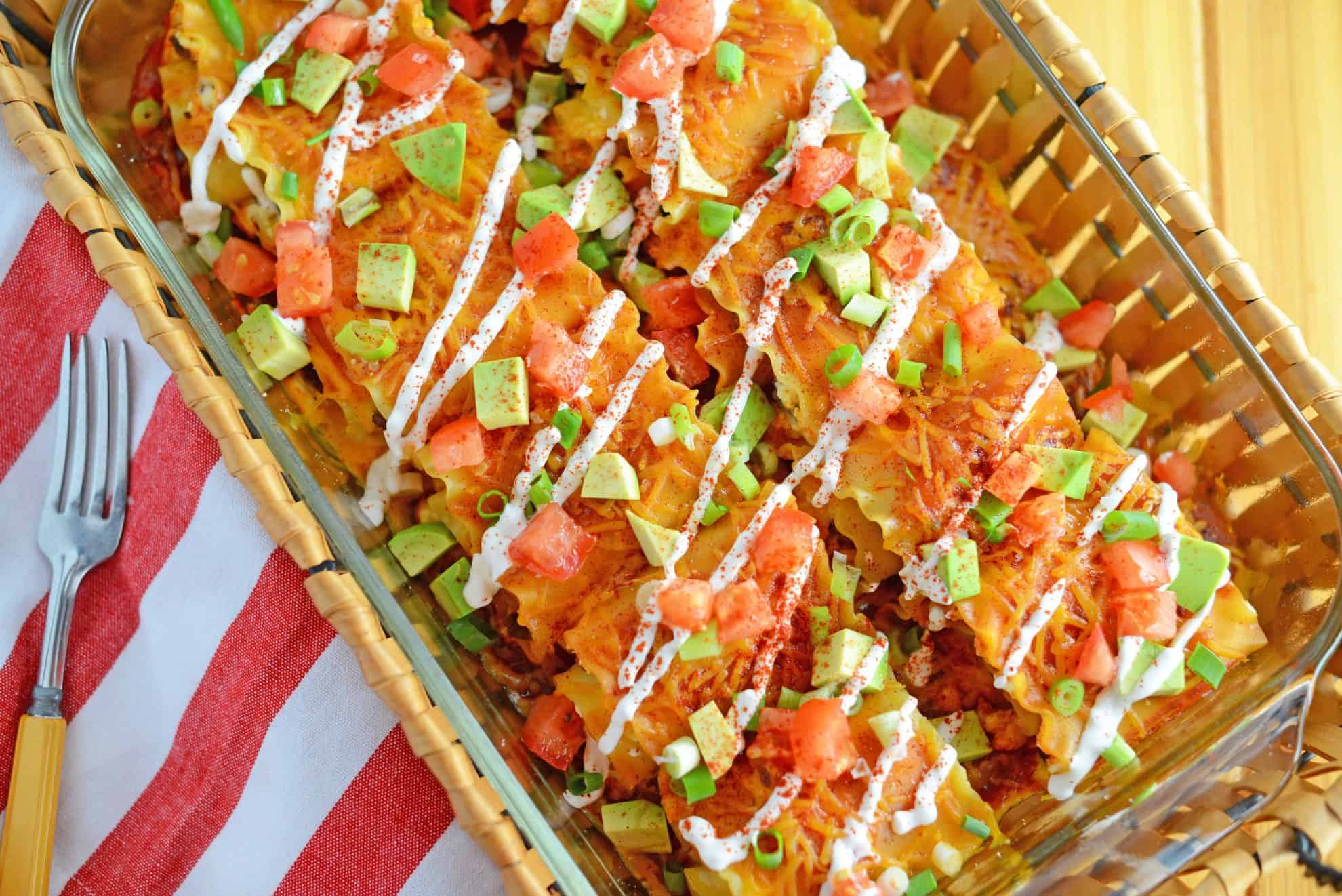 Mexican Lasagna Rolls are the best marriage of taco lasagna and traditional lasagna! They're so easy to put together, even the kids can help make them! #lasagnarollsrecipe #lasagnarollups #mexicanlasagnarecipes www.savoryexperiments.com