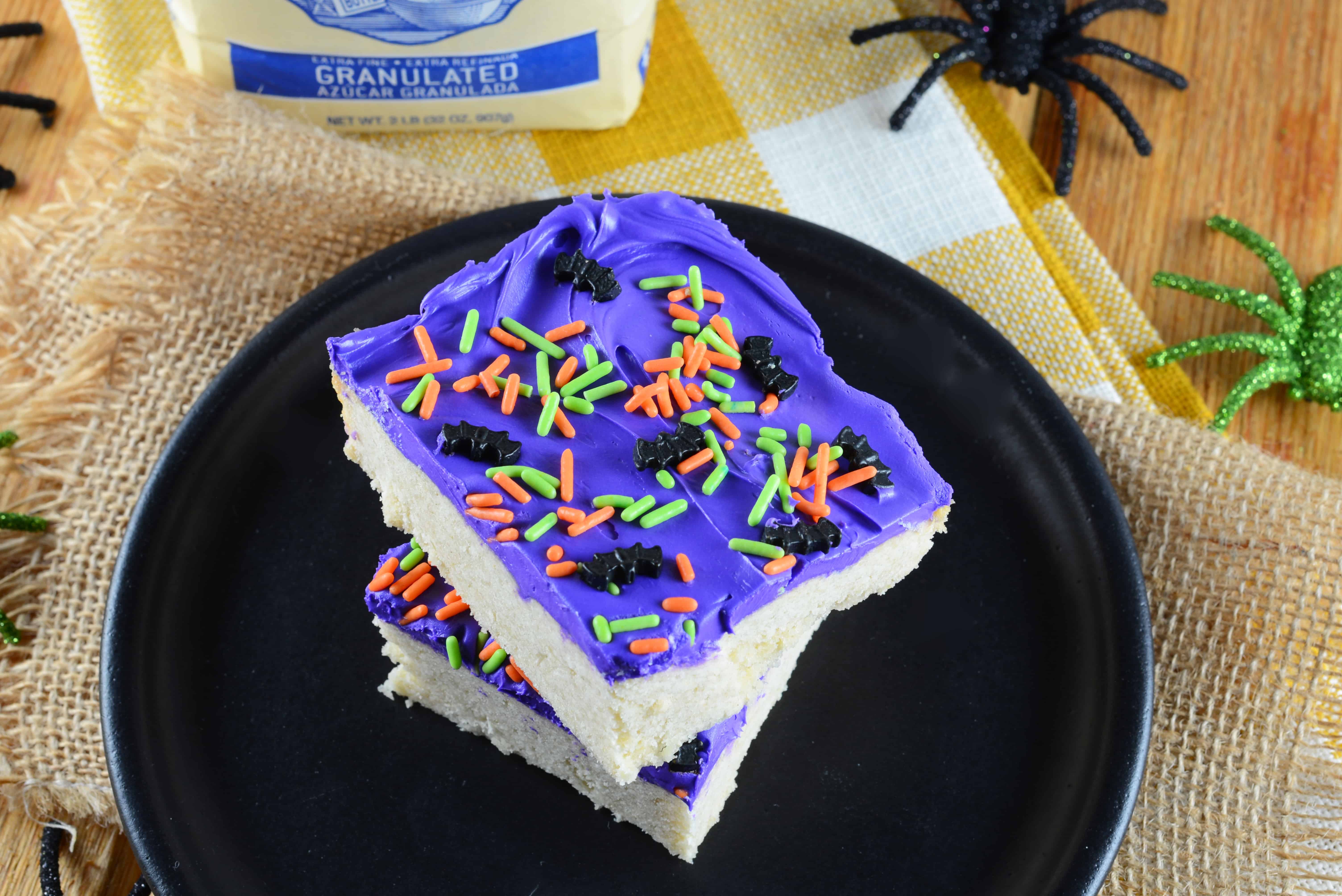 Halloween Sugar Cookie Bars are thick and chewy, frosted with a classic buttercream and topped with festive sprinkles.