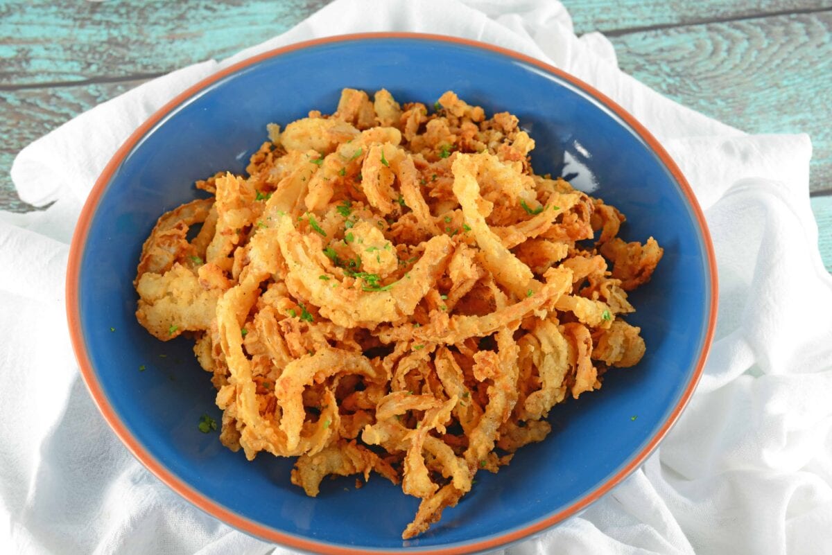 Onion Strings are buttermilk soaked and lightly seasoned fried onions. Perfect for topping burgers, a snack or green bean casserole.
