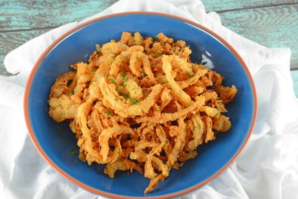 onion-strings Onion Strings are buttermilk soaked and lightly seasoned fried onions. Perfect for topping burgers, a snack or green bean casserole.