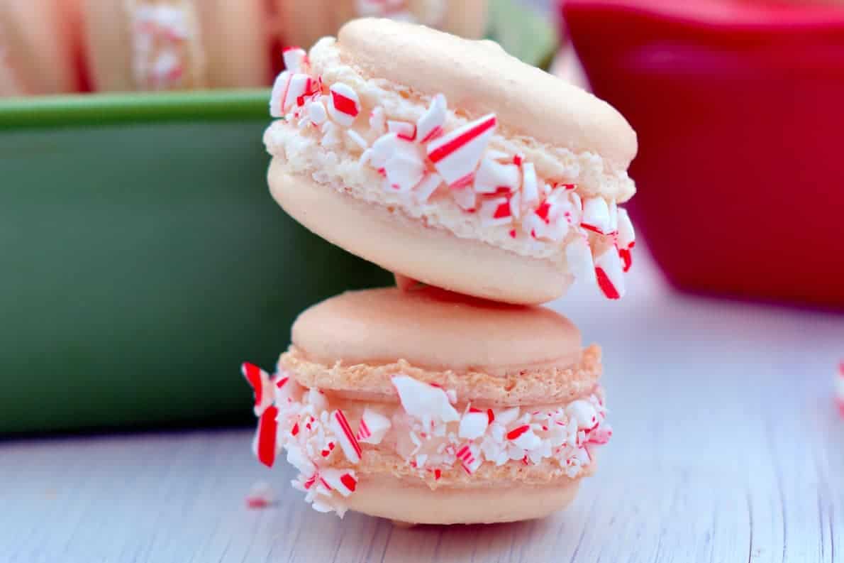 Peppermint Twist Macarons are an easy macaron recipe with a buttercream filling. Perfect recette macarons for Christmas cookies and holiday parties. #easymacaronrecipe #christmascookies www.savoryexperiments.com