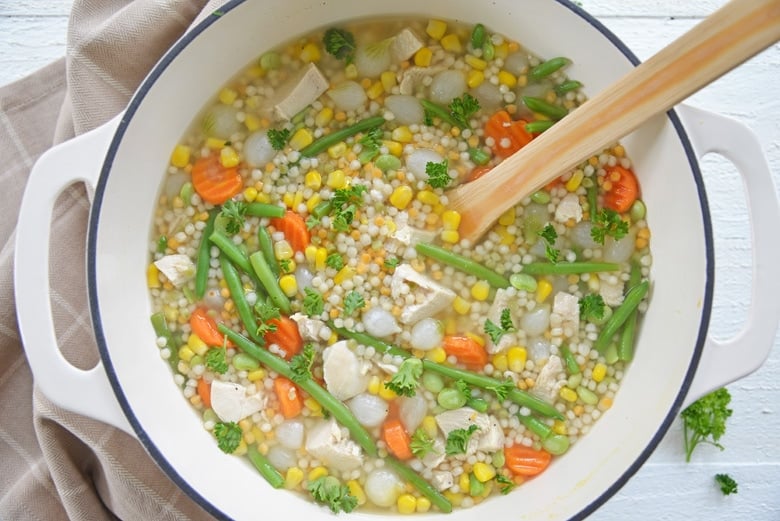 turkey noodle soup in a white dutch oven  
