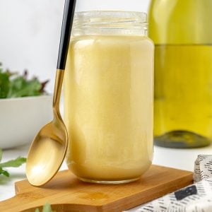 jar of beurre blanc sauce with a spoon