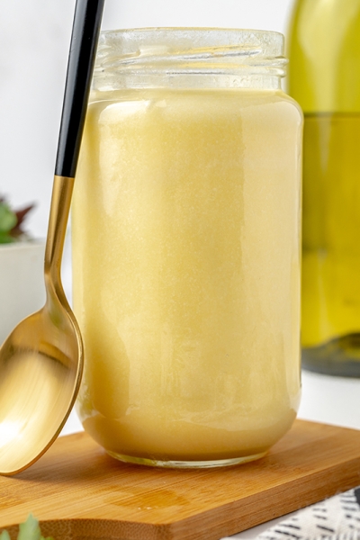 jar of beurre blanc sauce with a spoon