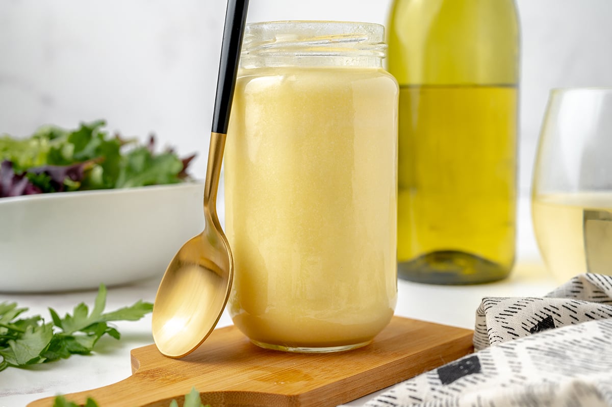 jar of beurre blanc sauce with a spoon