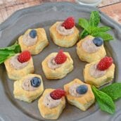 A cake with fruit on top of a wooden table