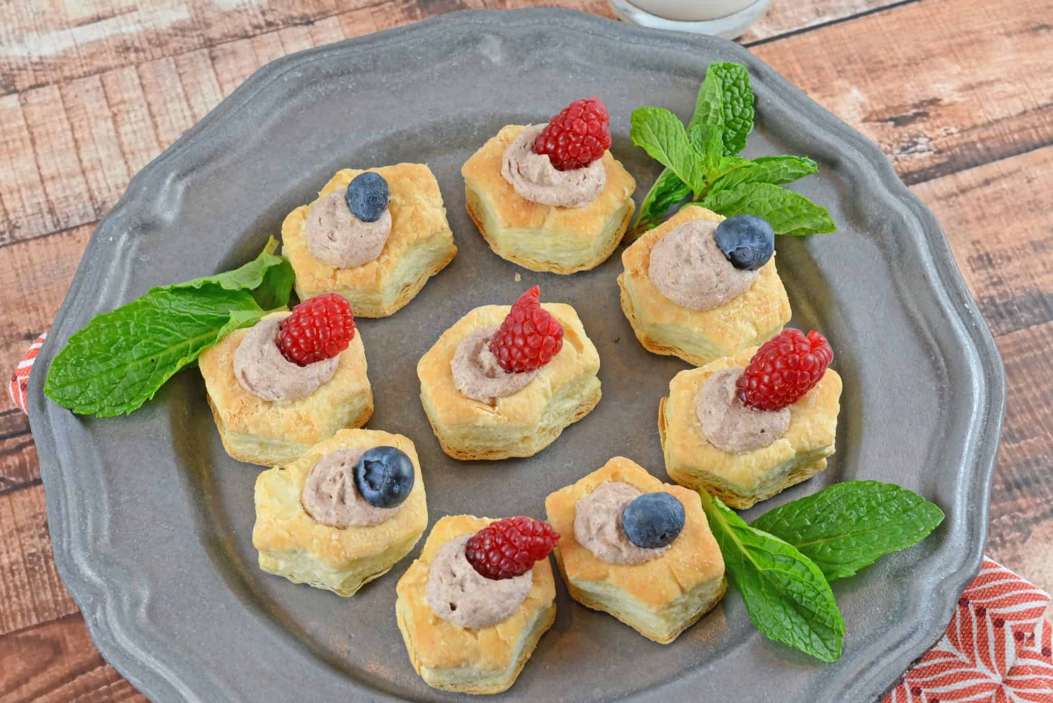 A cake with fruit on top of a wooden table