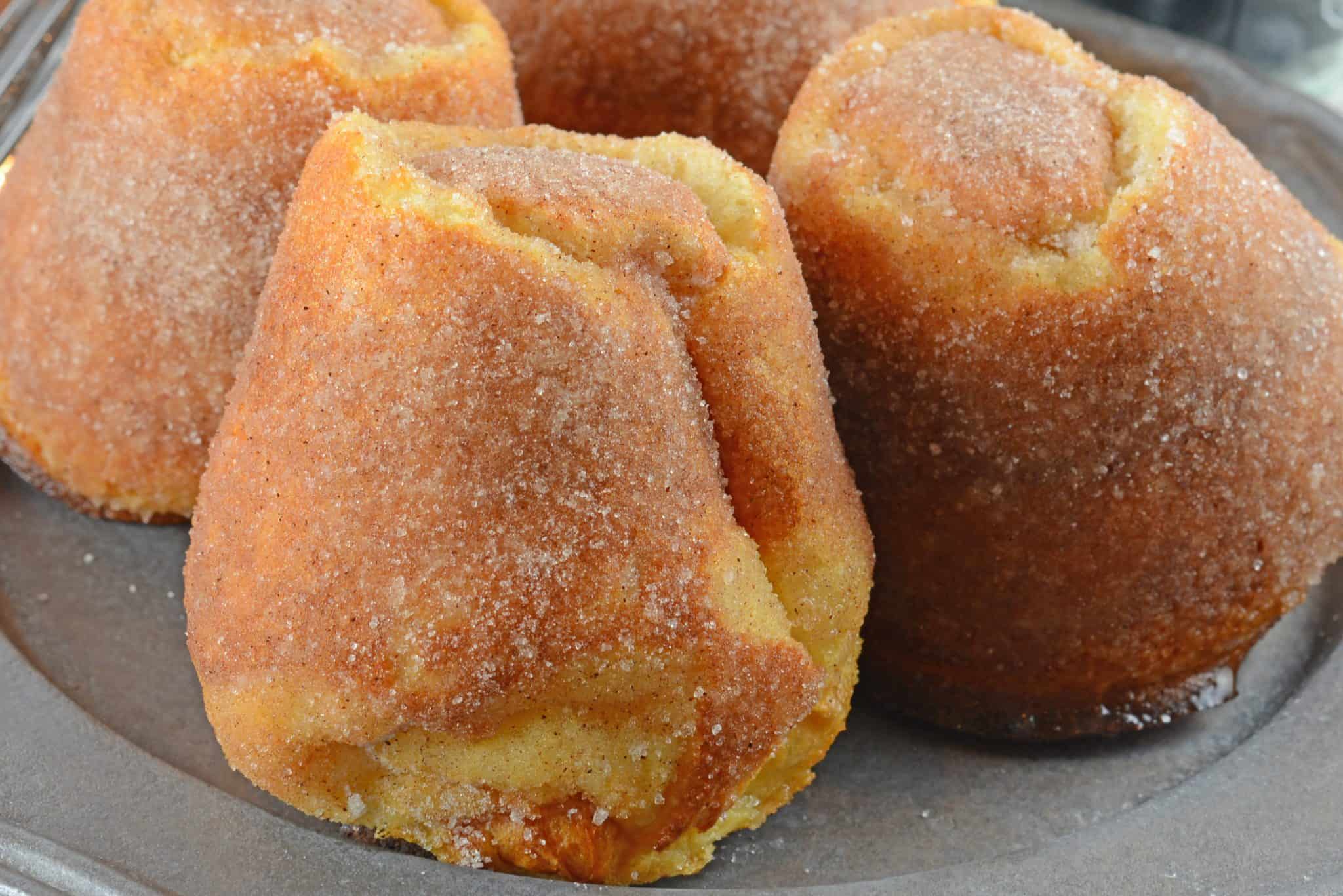 Cinnamon Sugar Popovers are easier to make then you think! A crispy outside and chewy inside coated with cinnamon and sugar, then drizzled in a fresh raspberry sauce. 