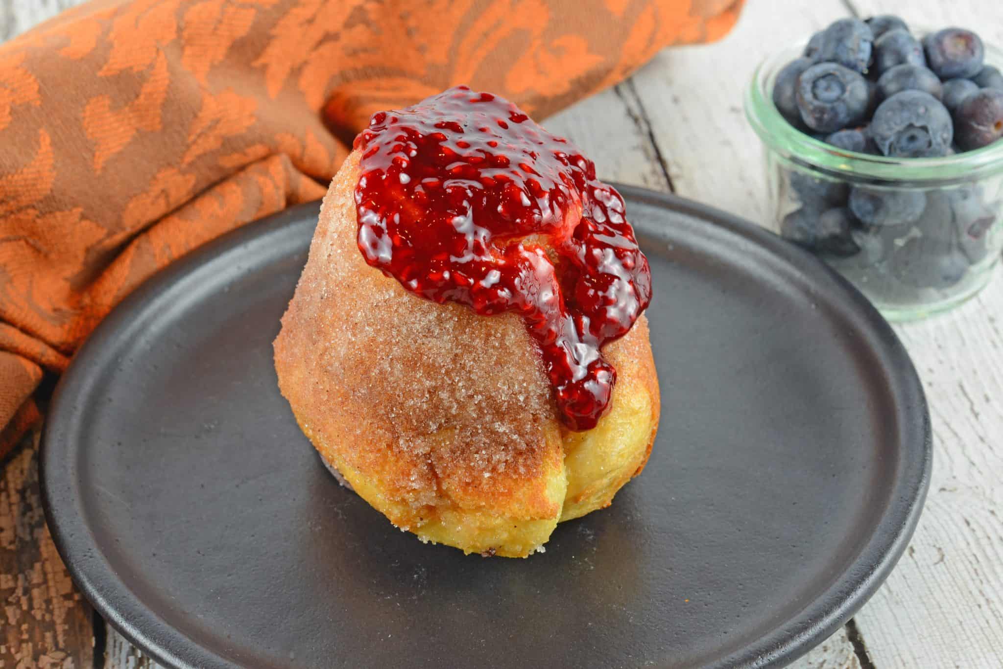 Cinnamon Sugar Popovers are easier to make then you think! A crispy outside and chewy inside coated with cinnamon and sugar, then drizzled in a fresh raspberry sauce.