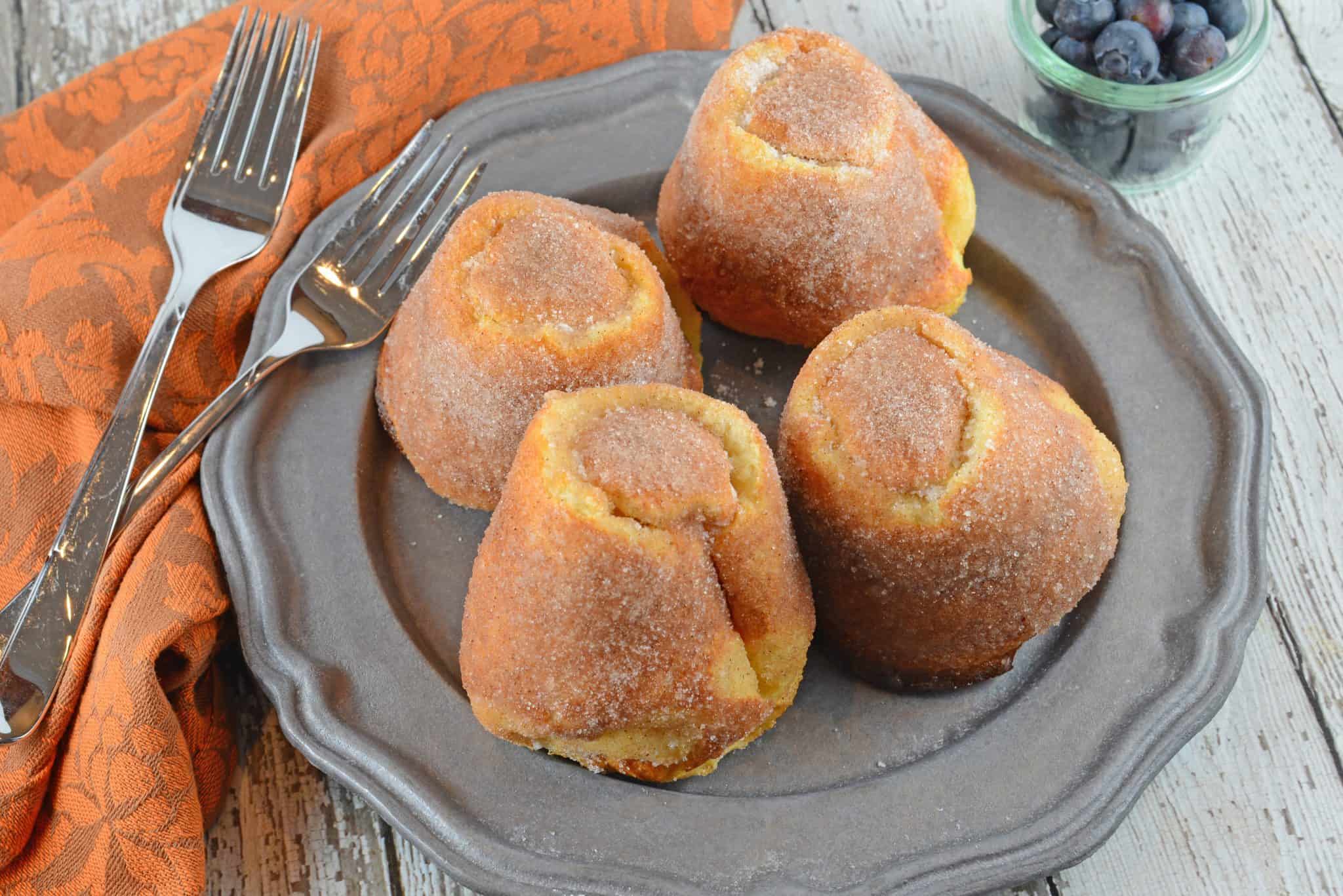 Cinnamon Sugar Popovers are easier to make then you think! A crispy outside and chewy inside coated with cinnamon and sugar, then drizzled in a fresh raspberry sauce. 