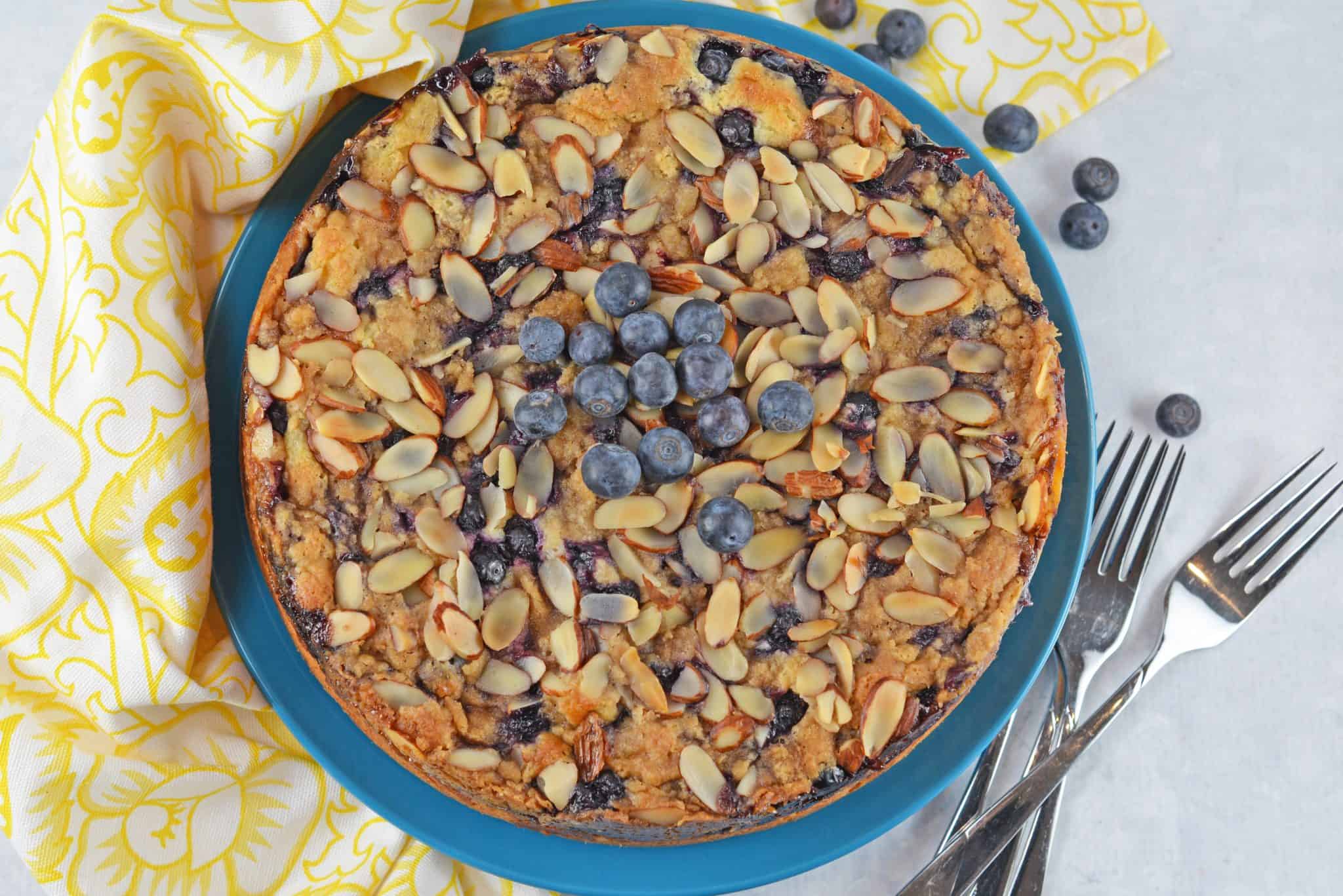 Blueberry Cream Cheese Coffee Cake is an easy coffee cake recipe with three layers of tender cake, silky cream cheese and almond streusel topping.