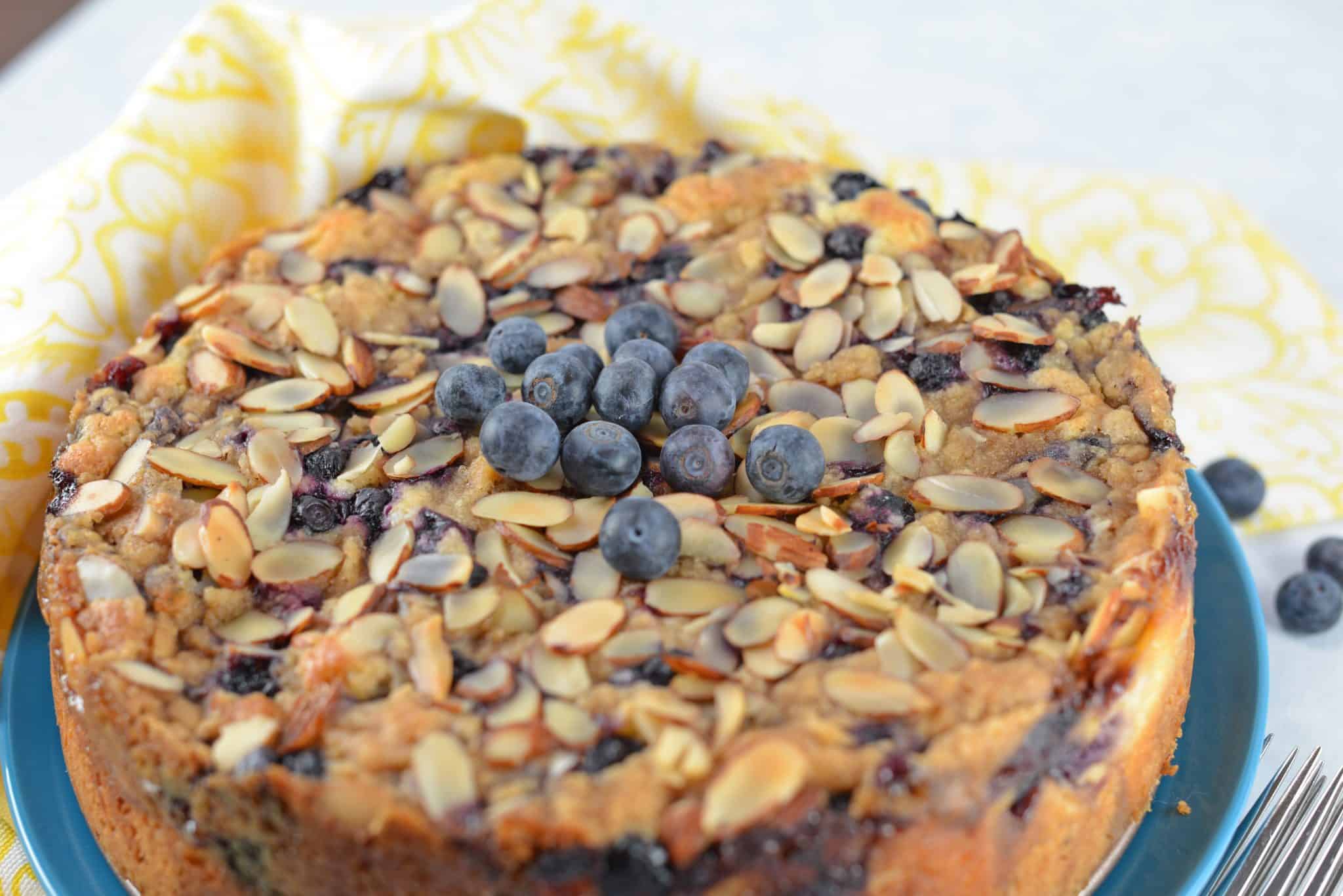 Blueberry Cream Cheese Coffee Cake is an easy coffee cake recipe with three layers of tender cake, silky cream cheese and almond streusel topping.