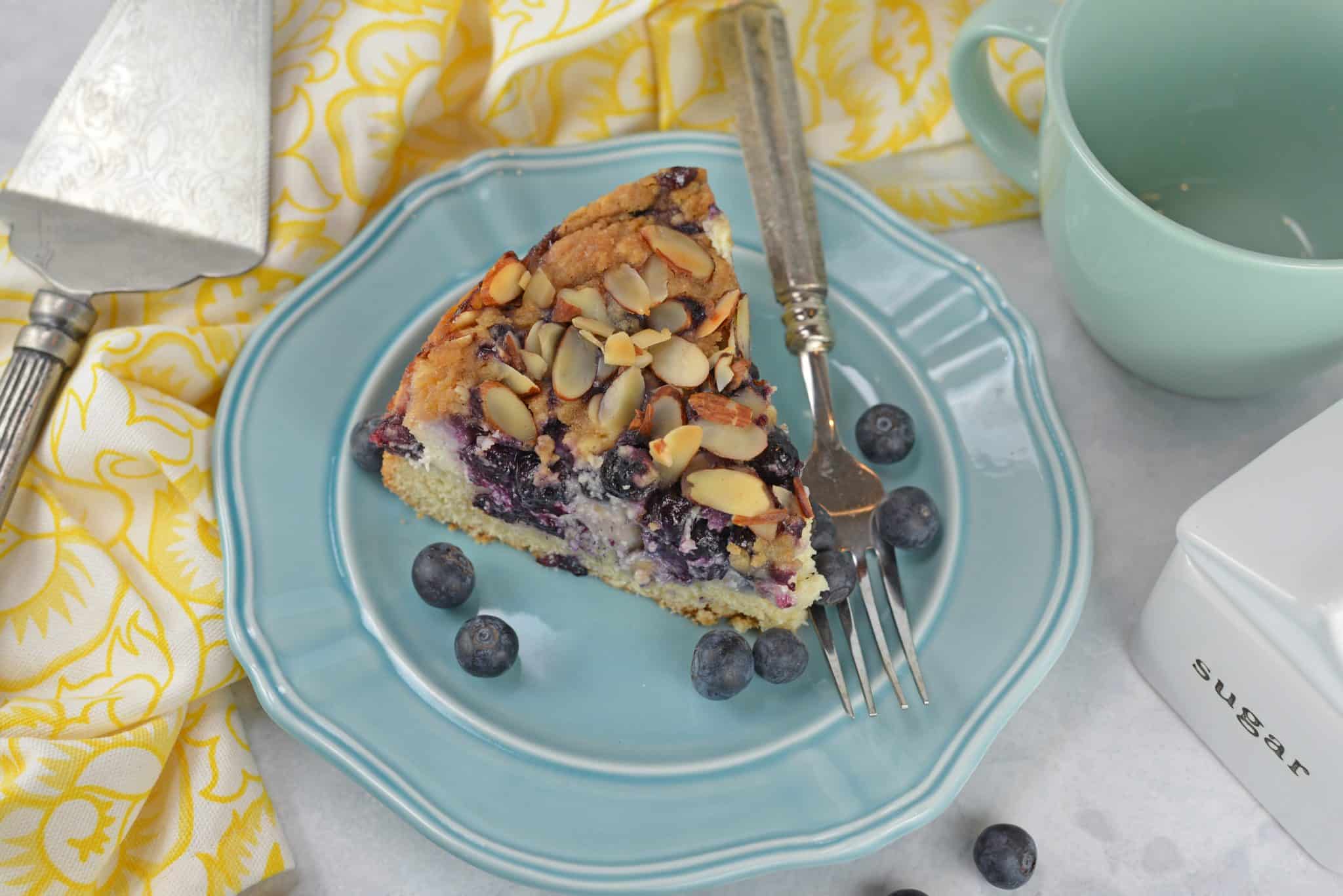 Blueberry Cream Cheese Coffee Cake is an easy coffee cake recipe with three layers of tender cake, silky cream cheese and almond streusel topping.